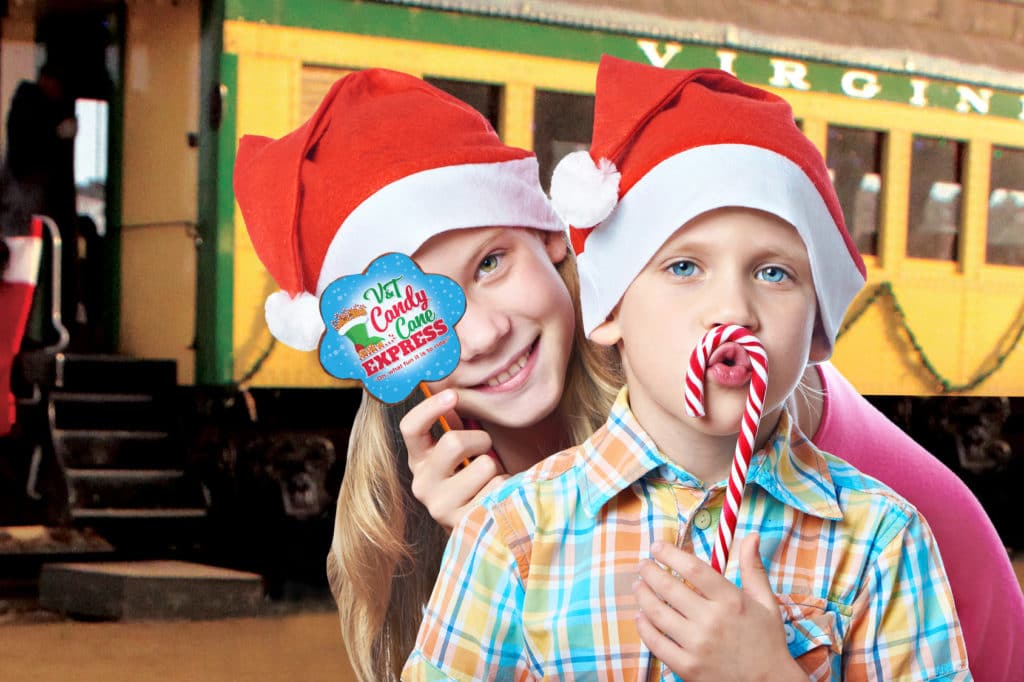kids in front of the candy cane express with lollipop and candy cane