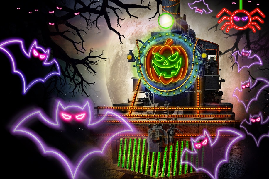 spooky image of V&T locomotive with neon bats, spiders overlaid and a pumpkin on the train